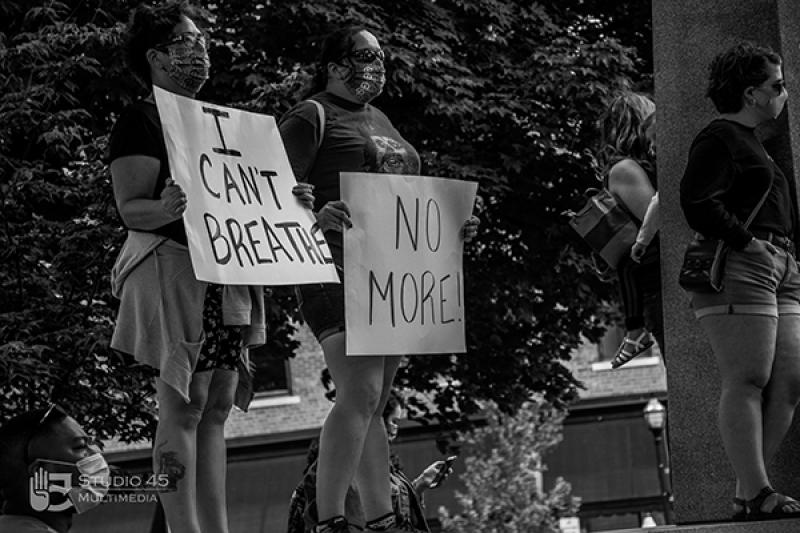 Two protesters hold signs at the Black Lives Matter protest in Mansfield in May 2020