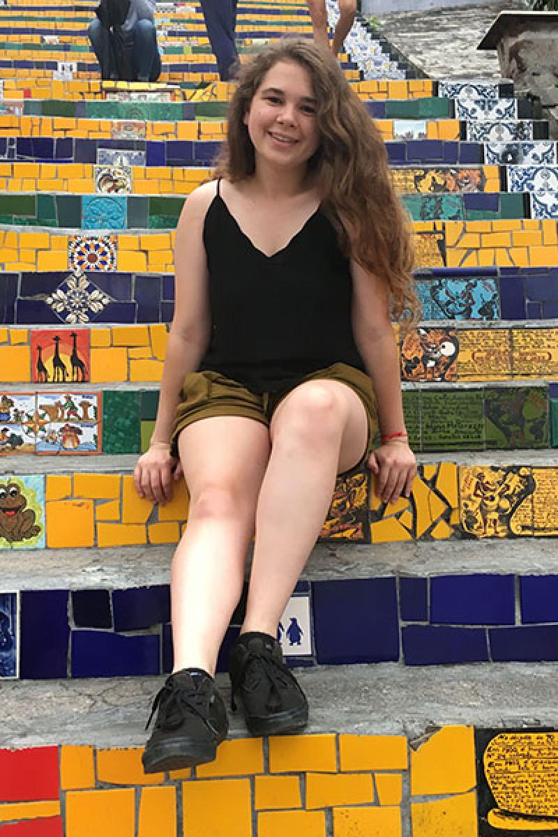 Emily Nothnagle on a flight of colorful stairs in Escadaria Selarón in Rio de Janeiro, Brazil