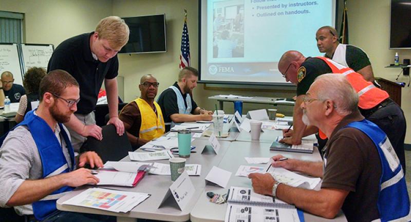 Alex McCarthy, director of the Tuscarawas County Homeland Security and Emergency Management Agency, interacting with health officials and first responders during an exercise. Alex McCarthy, director of the Tuscarawas County Homeland Security and Emergency Management Agency, interacting with health officials and first responders during an exercise.