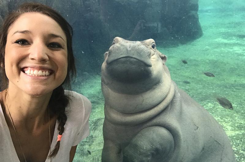 Angela Hatke with Fiona the baby hippo Arts and Sciences alumna Angela Hatke with Fiona the baby hippo
