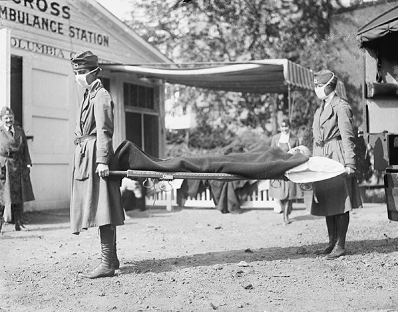Two Red Cross carriers hold a patient with Spanish Flu Two Red Cross carriers hold a patient with Spanish Flu