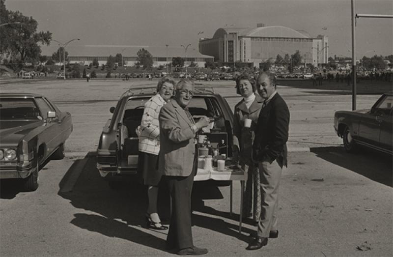 Fans tailgating at a football game in 1968. Fans tailgating at a football game in 1968.