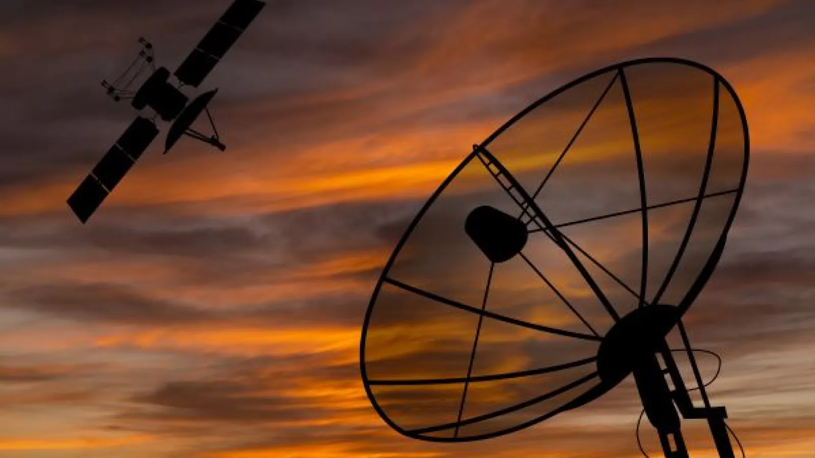 Satellite dish and satellite in front of a sunset