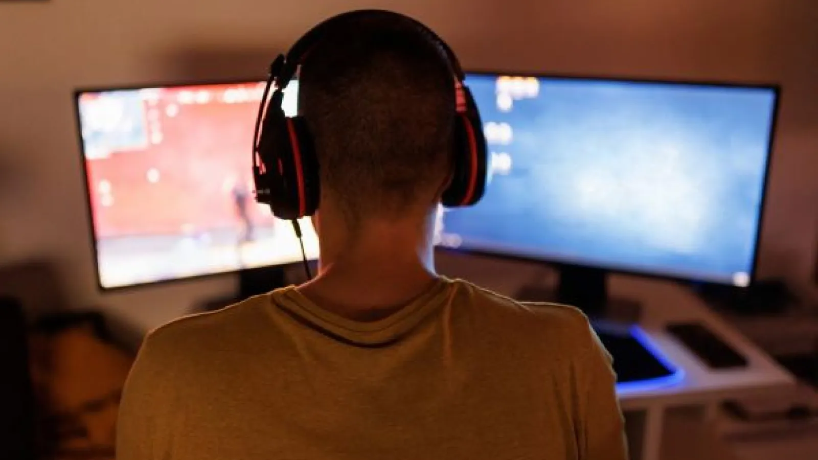 a person in headphones playing a PC game