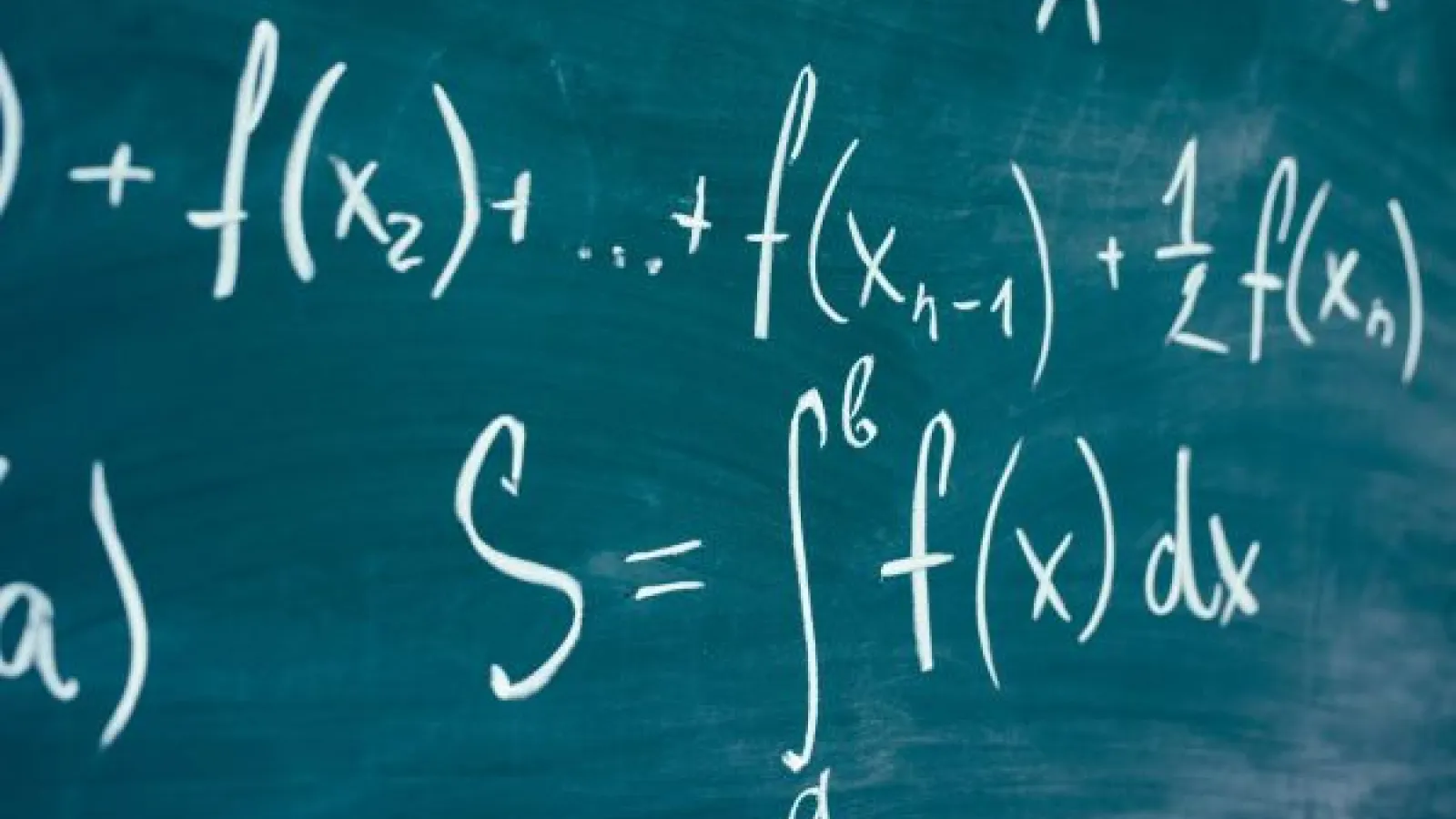 a chalkboard showing calculus formulas