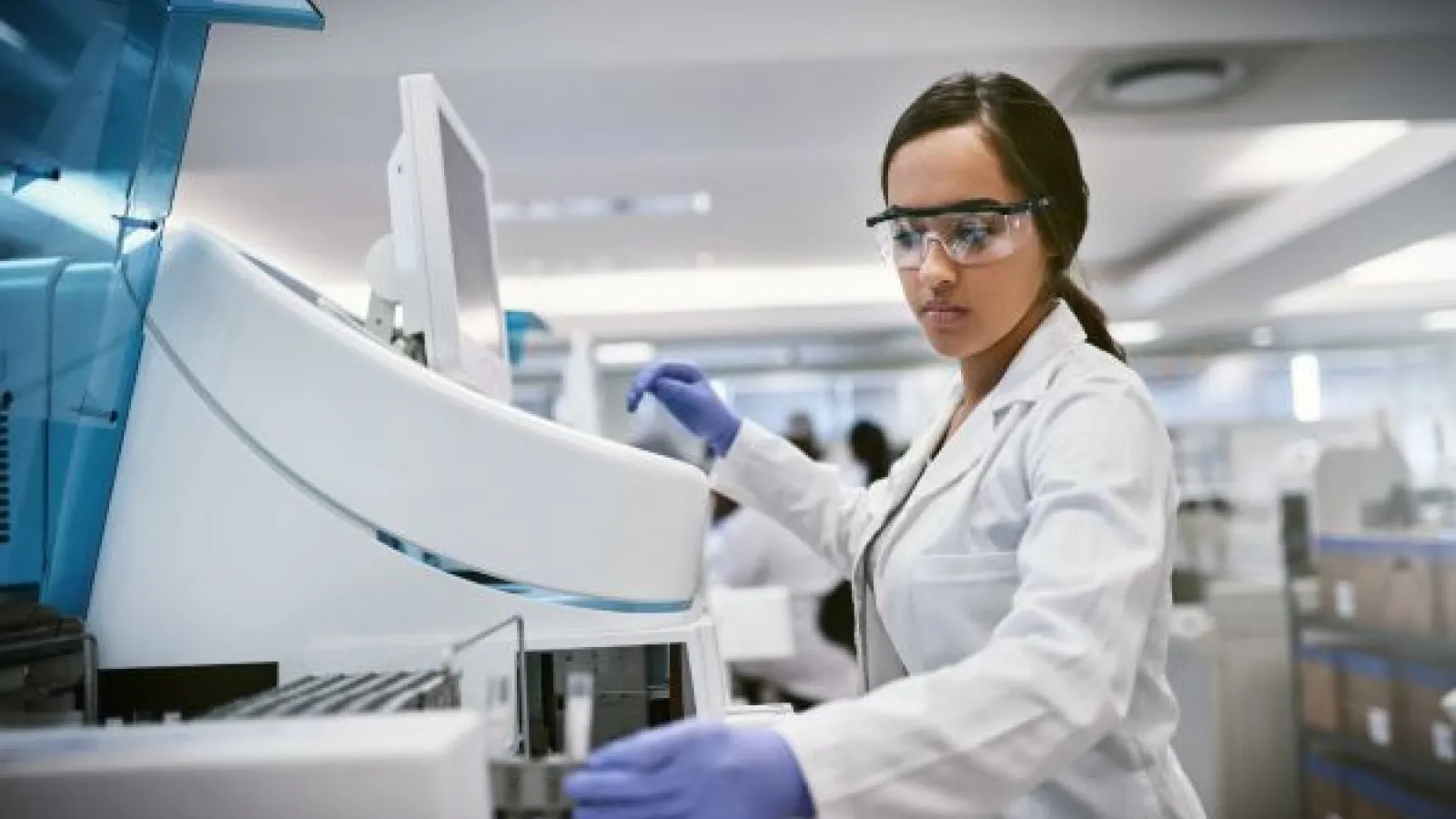 a young female researcher works in a biomedical lab