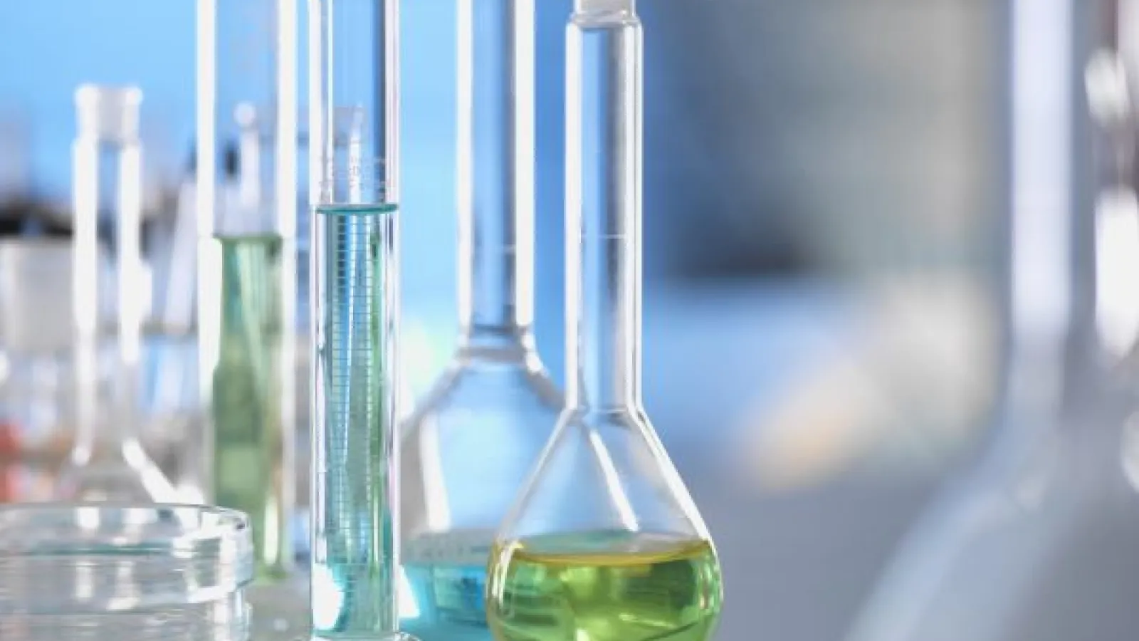 clear test tubes and flasks holding blue and green liquids
