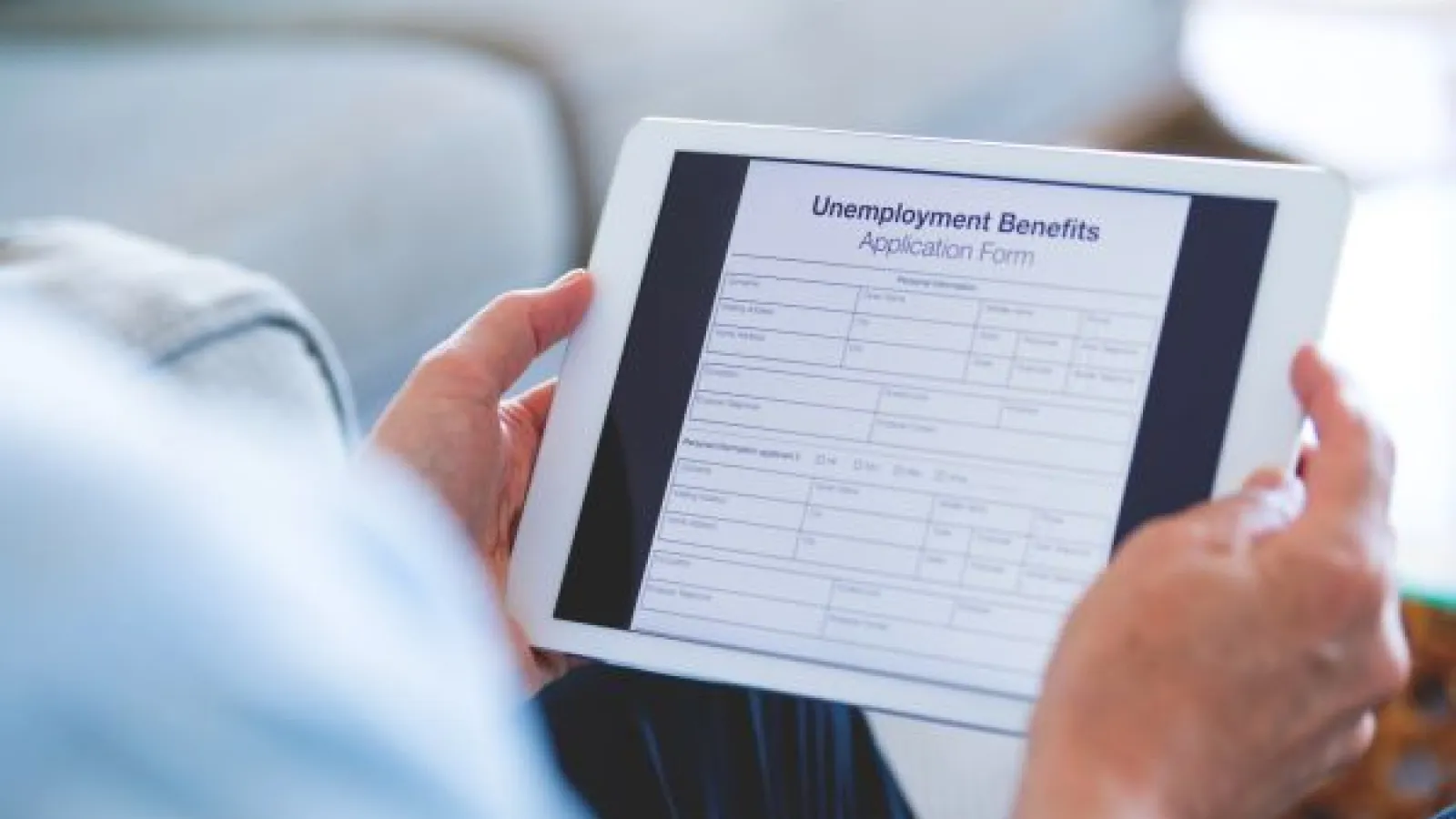 a tablet showing unemployment benefits information