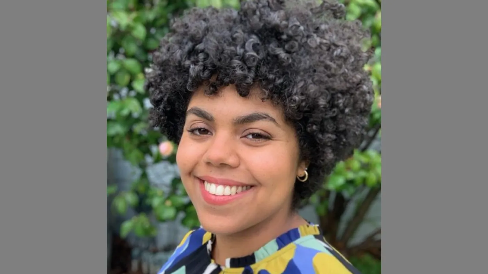a woman with dark curly hair