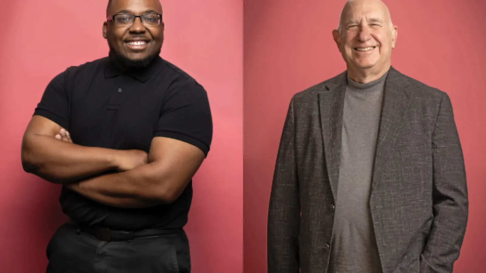 a young black man and an older white man smile at the camera