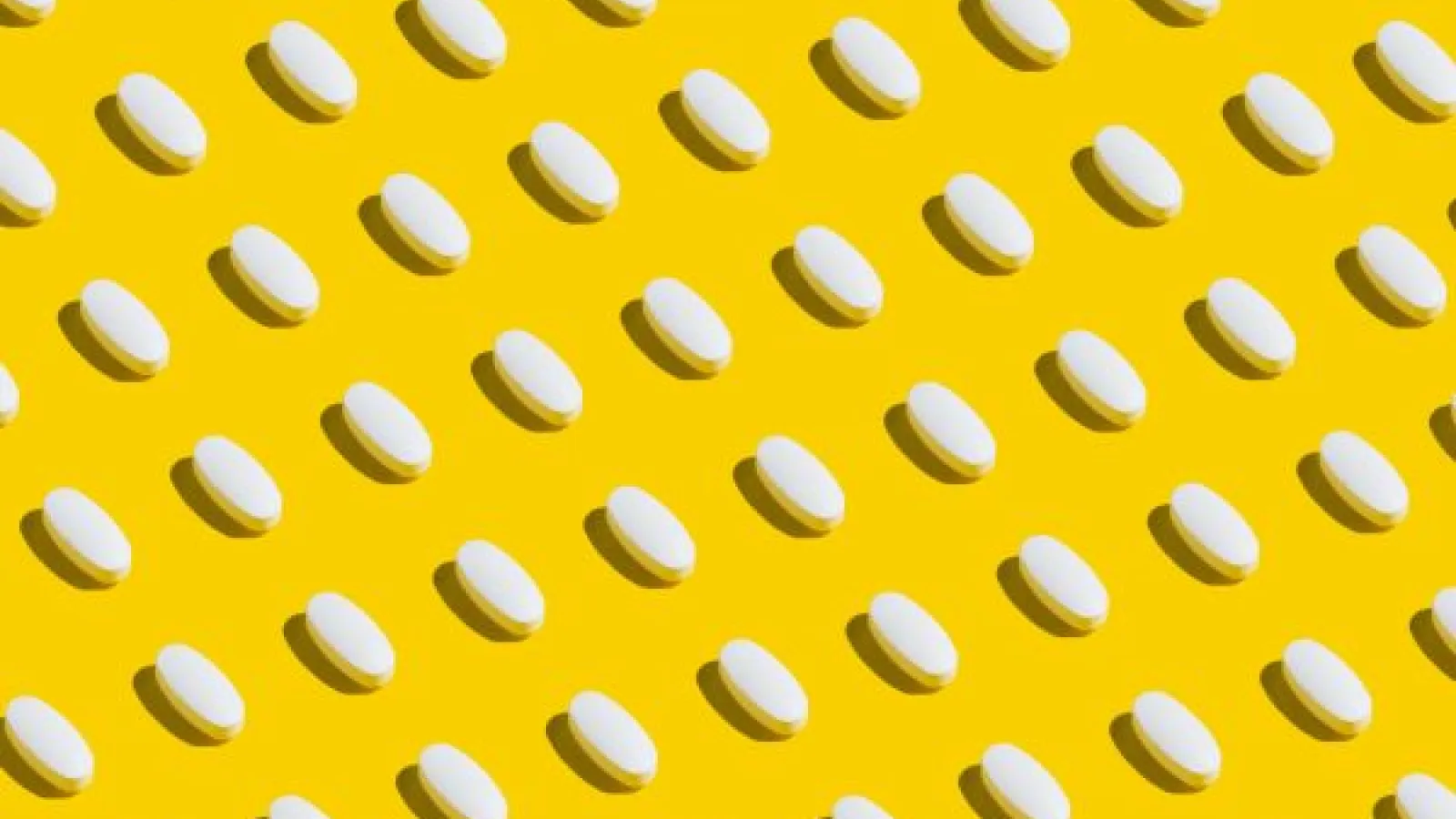 white pills on a yellow background