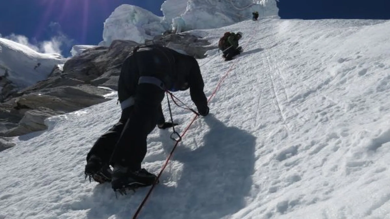 people climbing a snowy mountain