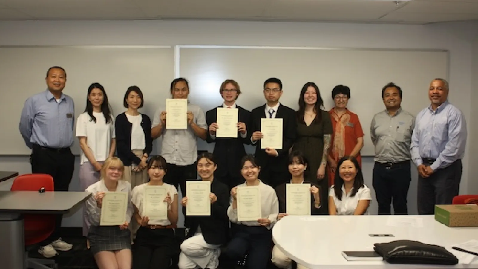A group photo with students and faculty from Ohio State, the University of Osaka and employees from OTC Daihen