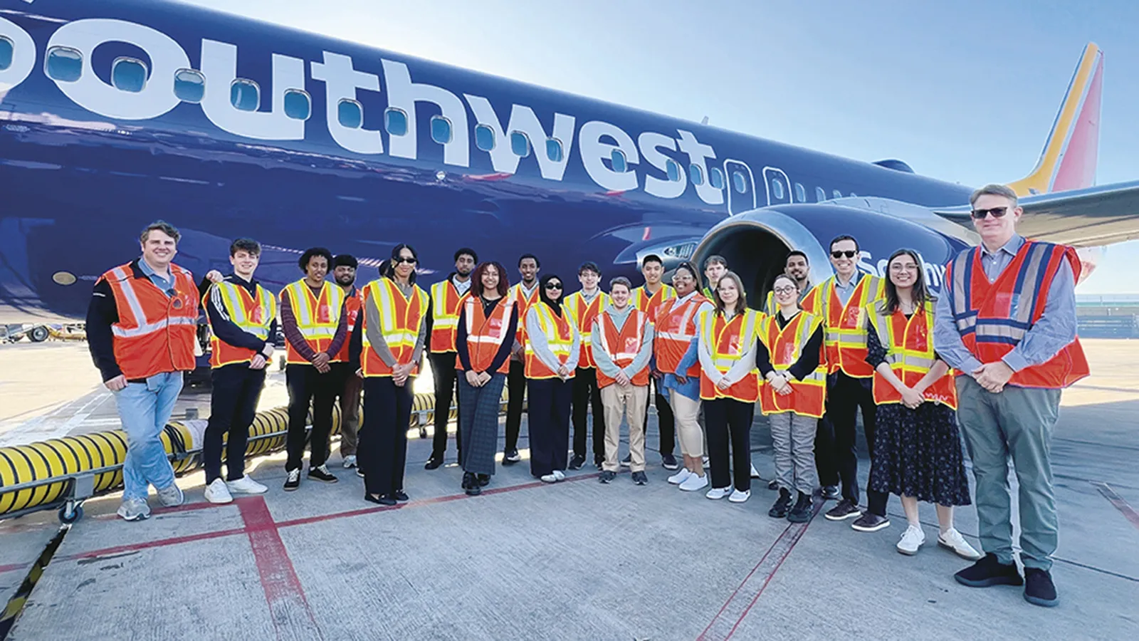 Students in front of a Southwest plane