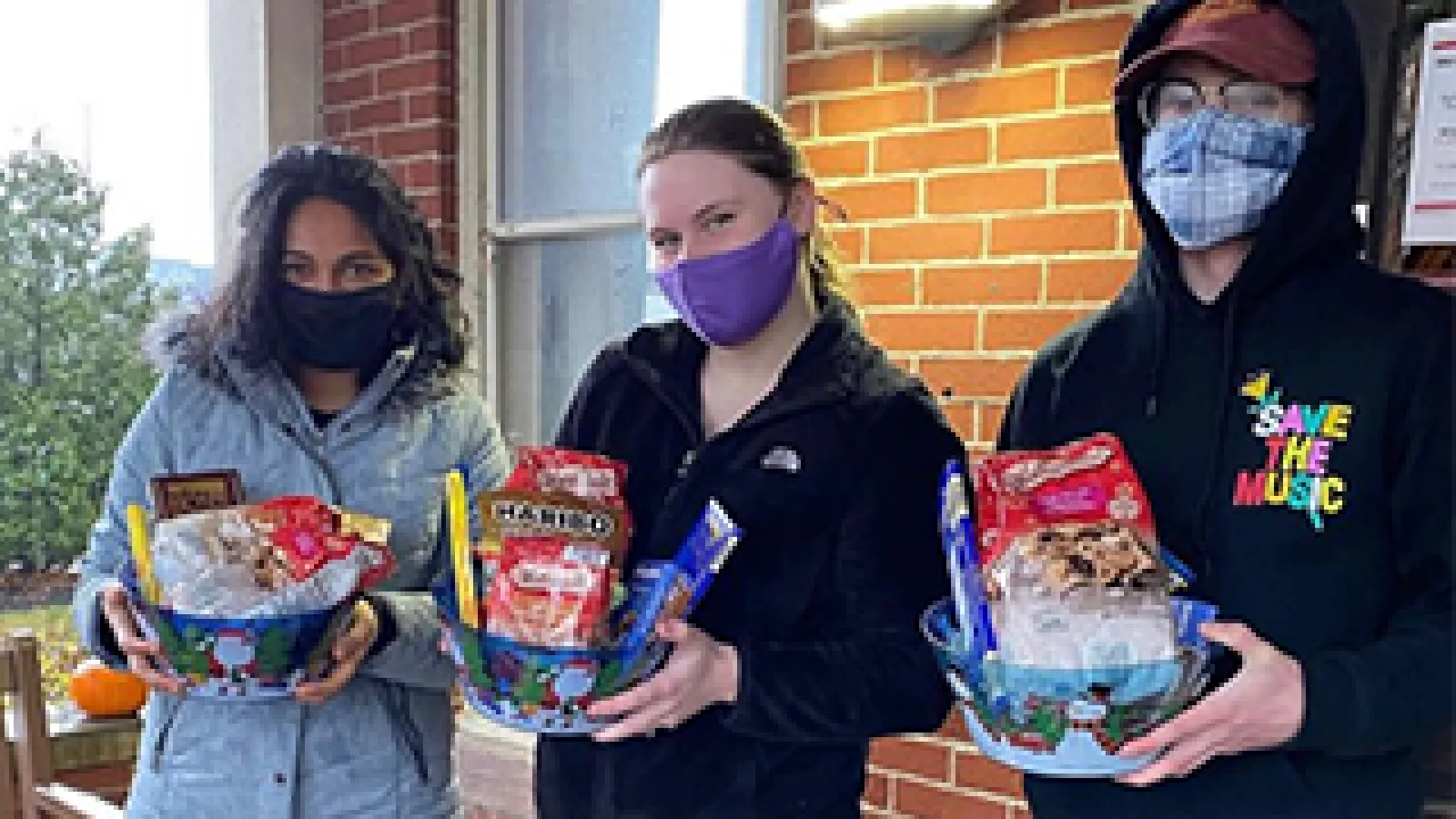 German Club members carrying holiday baskets