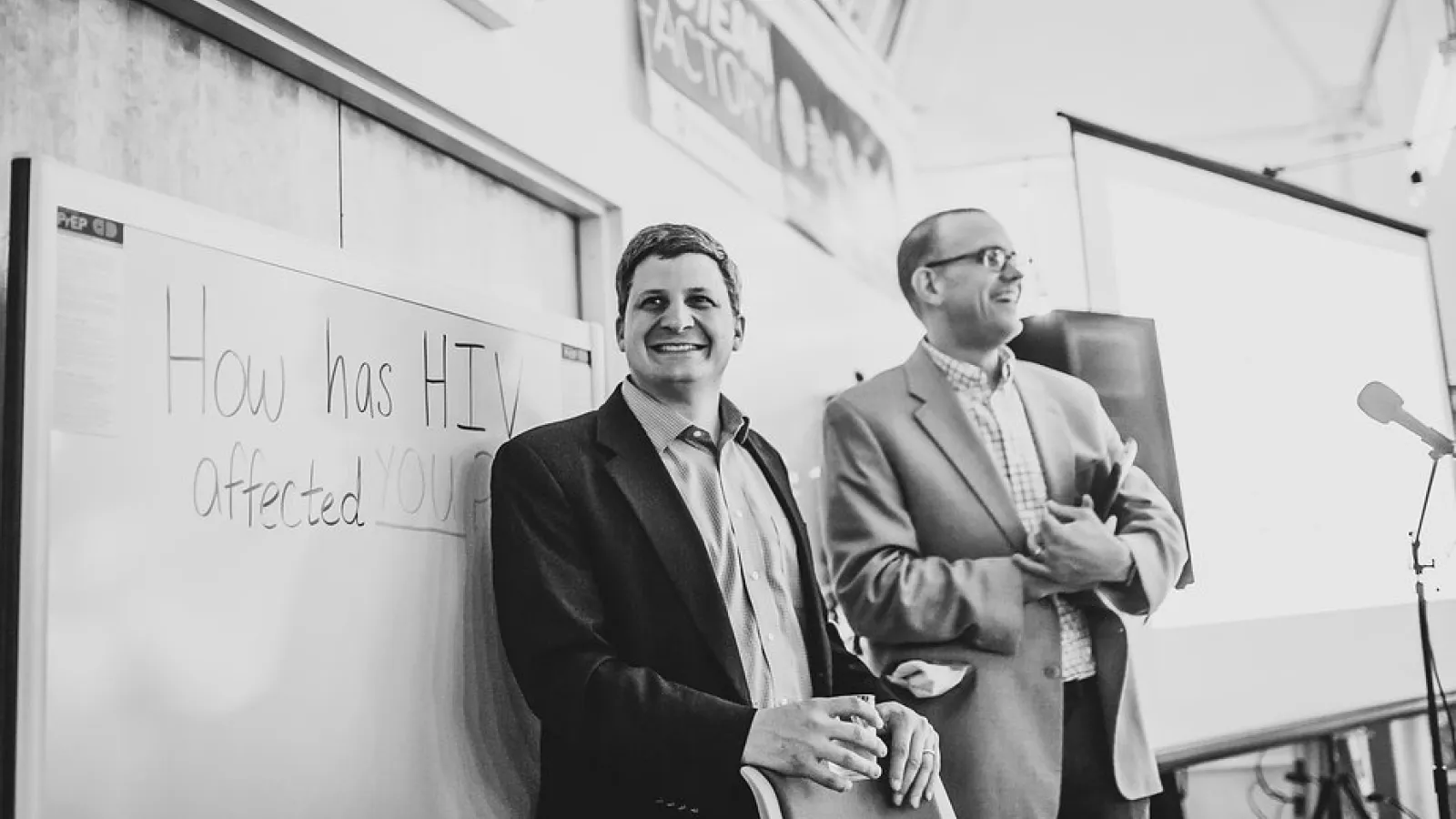 Associate professors Jesse Kwiek (left) of microbiology and Thomas McDow of history at the STEAM Factory for an event that concludes their co-taught course on HIV. Photo courtesy Paul Woo, Wandering Woo Photography