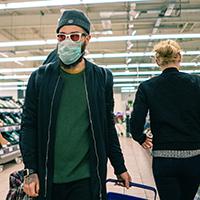 Man in grocery store wearing mask Man in grocery store wearing mask