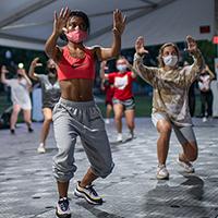 Students dance during a hip hop dance class in a specialized outdoor tent on the South Oval. Students dance during a hip hop dance class in a specialized outdoor tent on the South Oval.