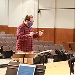 Jae Park conducts during rehearsal.