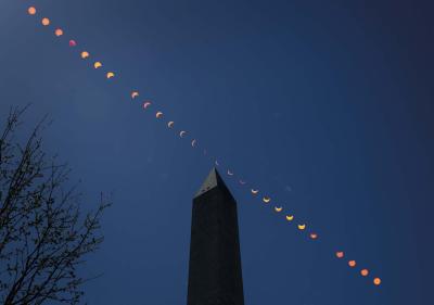 This composite image of multiple exposures shows the progression of a partial solar eclipse over the Washington Monument, Monday, April 8, 2024, in Washington.