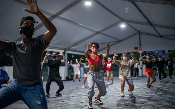 Dancers performing in a large tented space