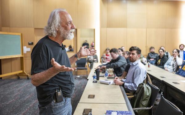 Pierre Agostini speaking to students in the classroom