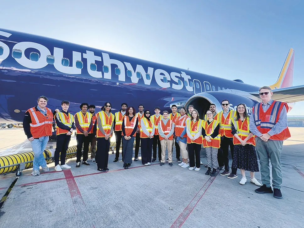 Students in front of a Southwest plane