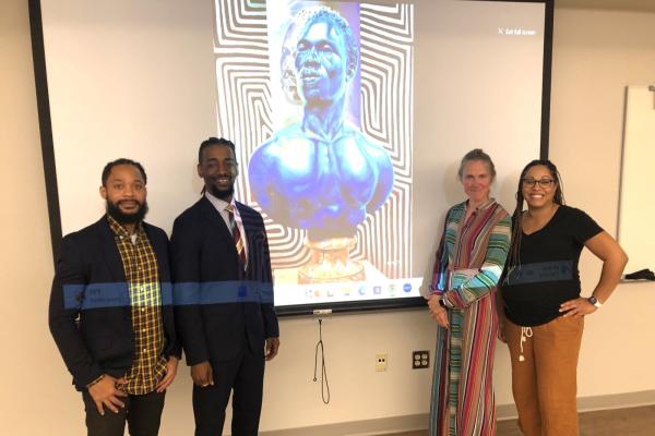 Terron Banner (left), Arris' J. Cohen, Merijn van der Heijden and Monica Stigler are pictured in front of a slide of Cohen's work.