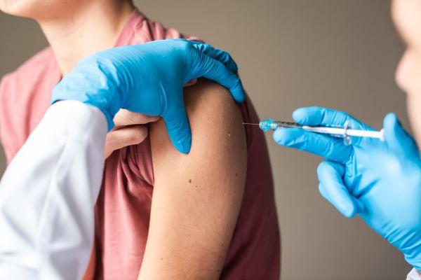 a nurse administers a vaccine