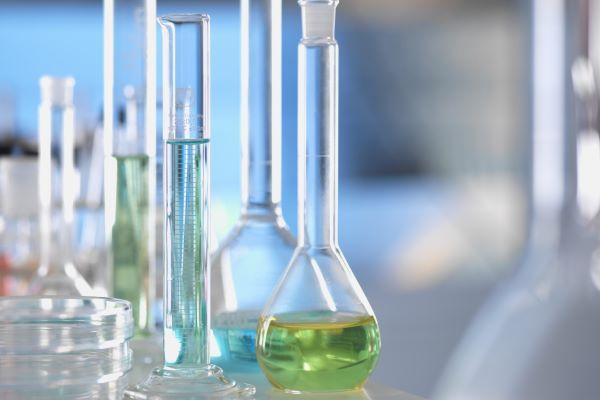 clear test tubes and flasks holding blue and green liquids