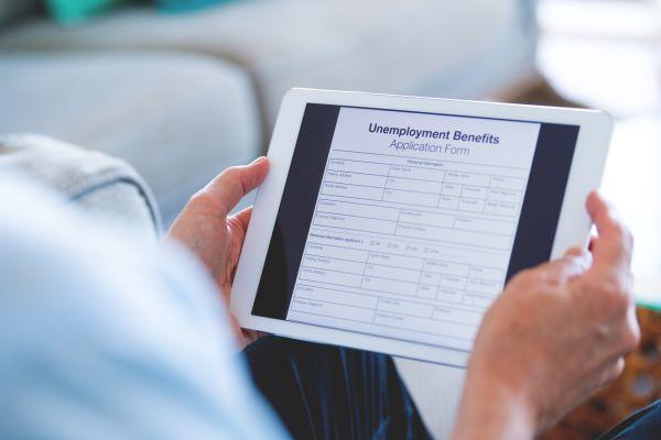 a tablet showing unemployment benefits information