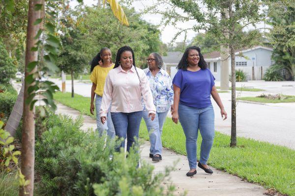 Black women walking through a neighborhood