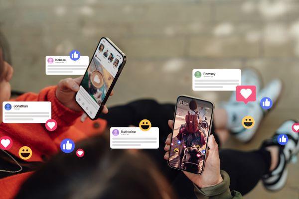 closeup of phones displaying social media messages and emojis