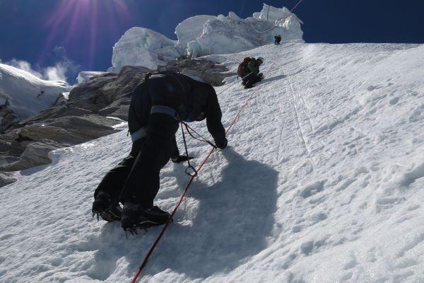 people climbing a snowy mountain