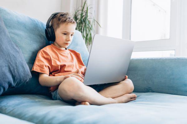 a young child watching a video on a laptop