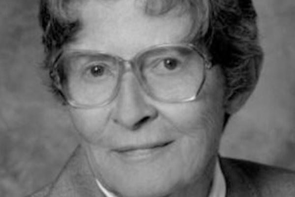 A closeup of Joan Huber, a woman wearing glasses.