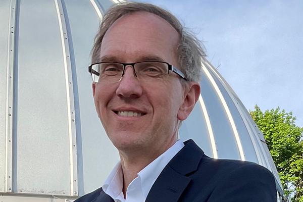 Joseph Shields by the Large Binocular Telescope. Photo courtesy Ann Fidler
