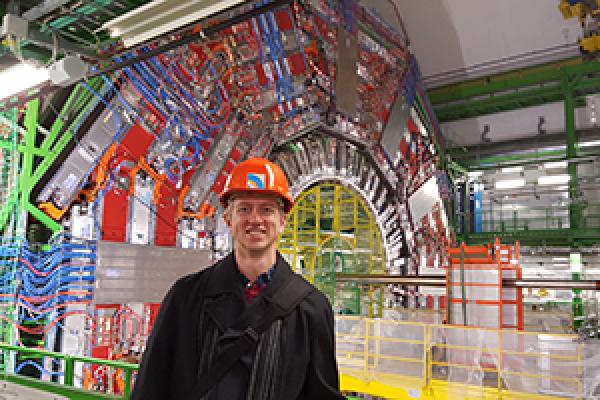 Tony Lefeld, a PhD candidate in the Department of Physics, stands in front of the CMS detector at the Large Hadron Collider at CERN in Geneva, Switzerland. Tony Lefeld, a PhD candidate in the Department of Physics, stands in front of the CMS detector at the Large Hadron Collider at CERN in Geneva, Switzerland.