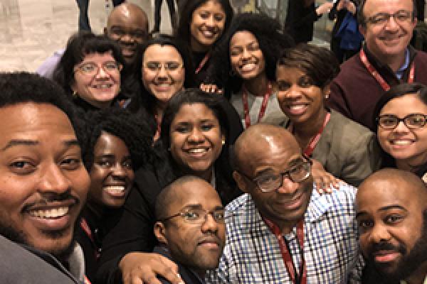 Trevon Logan poses with mentees of the AEA Mentoring Program.